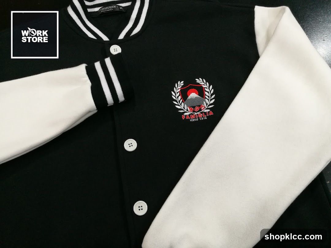 Black and white varsity jacket with embroidered emblem
