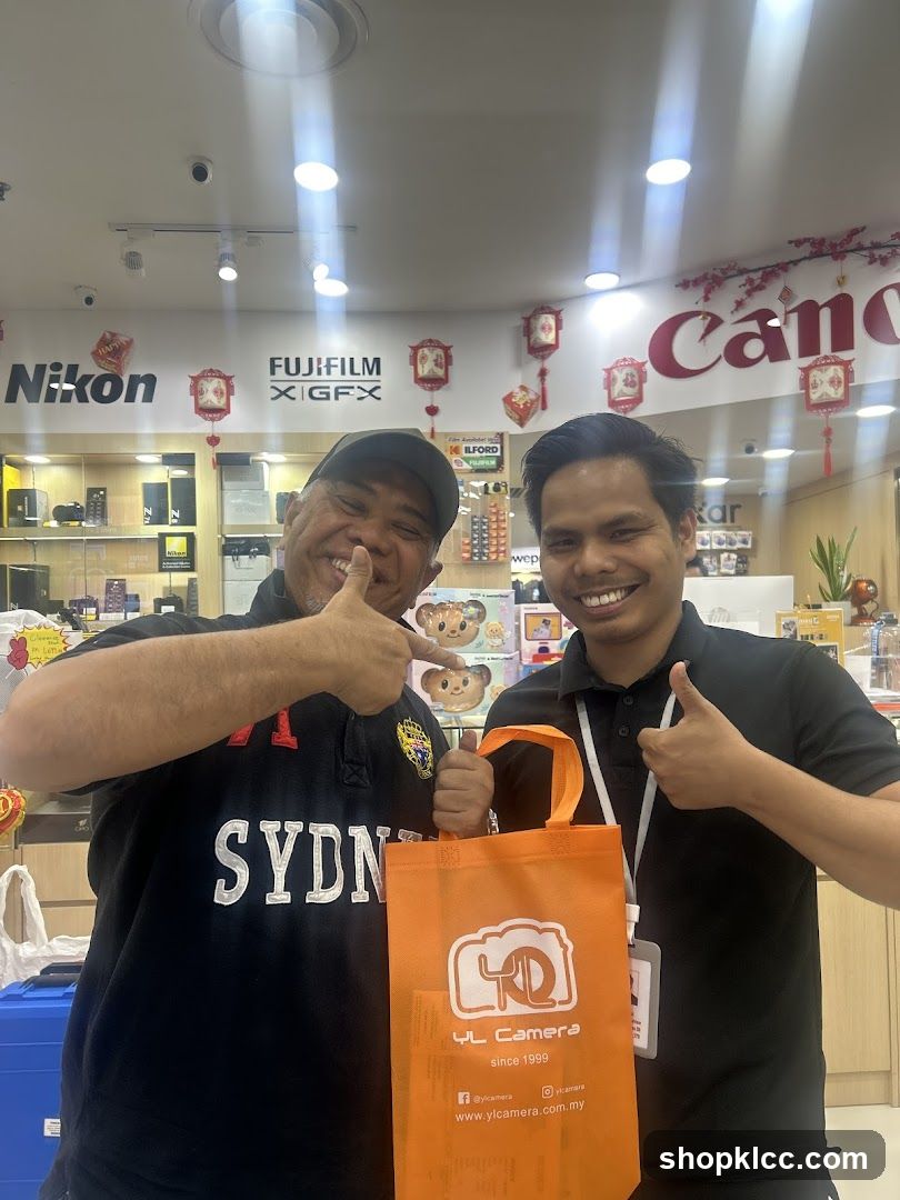 Two men posing with a shopping bag