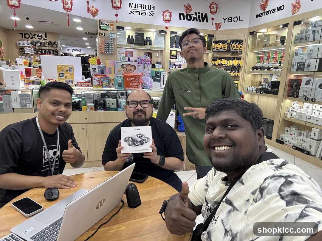 Four men in a camera store