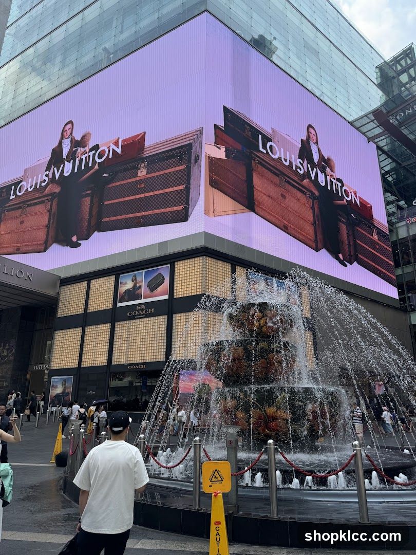 Louis Vuitton and Coach Advertisement with Fountain