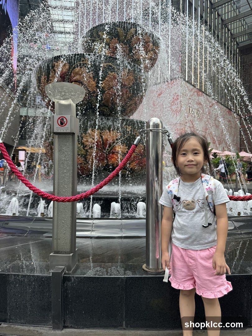 Girl Poses in Front of a Fountain