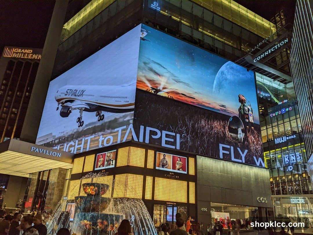 Nighttime Cityscape with Digital Billboards and Fountain