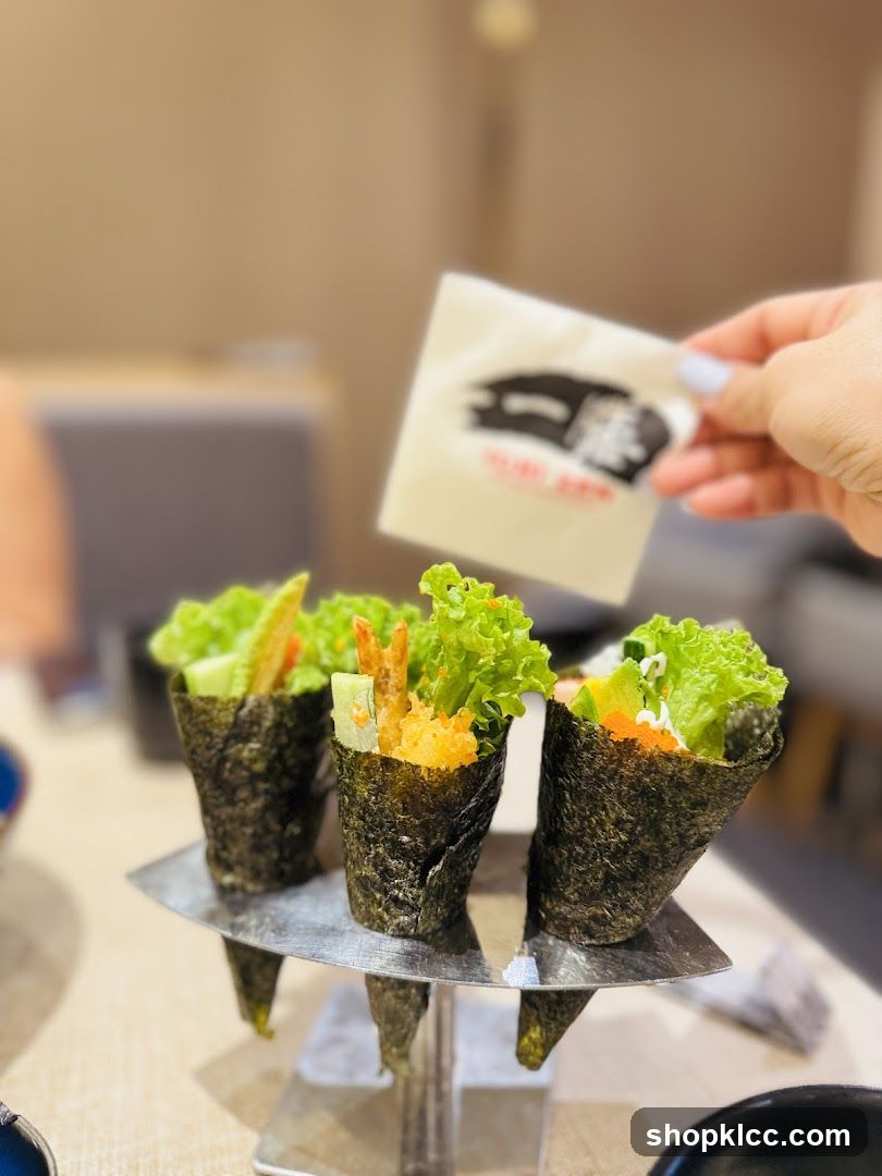 Hand holding a napkin over sushi cones