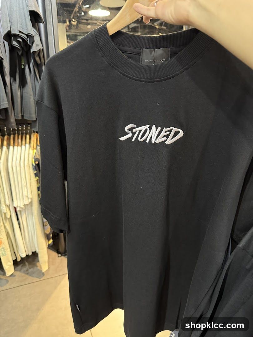 Black T-shirt with "STONED" logo