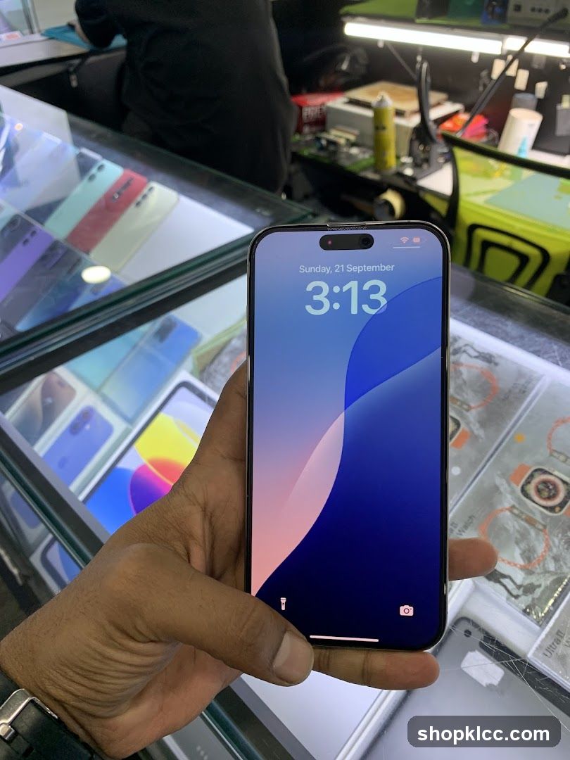 Hand holding a smartphone in a store