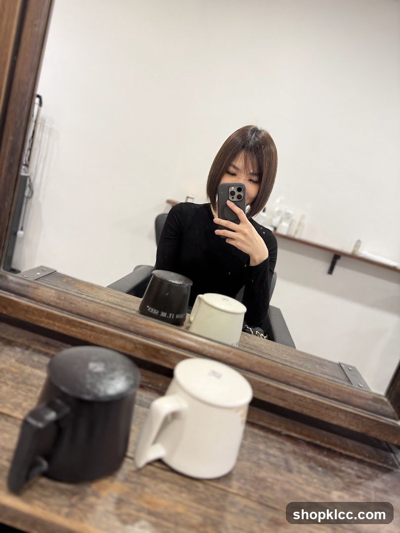 Woman Taking Mirror Selfie in Salon