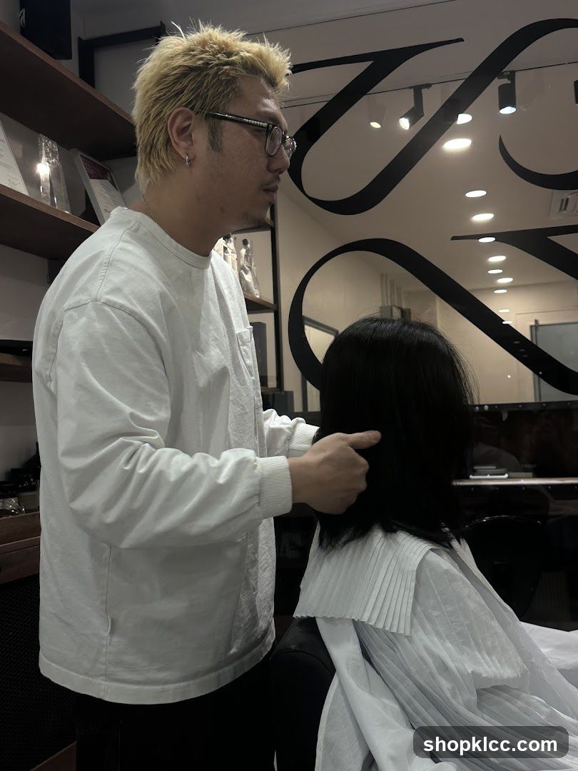 Hairdresser styling client's hair