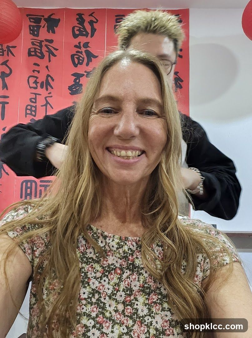 Woman smiling with calligraphy in background