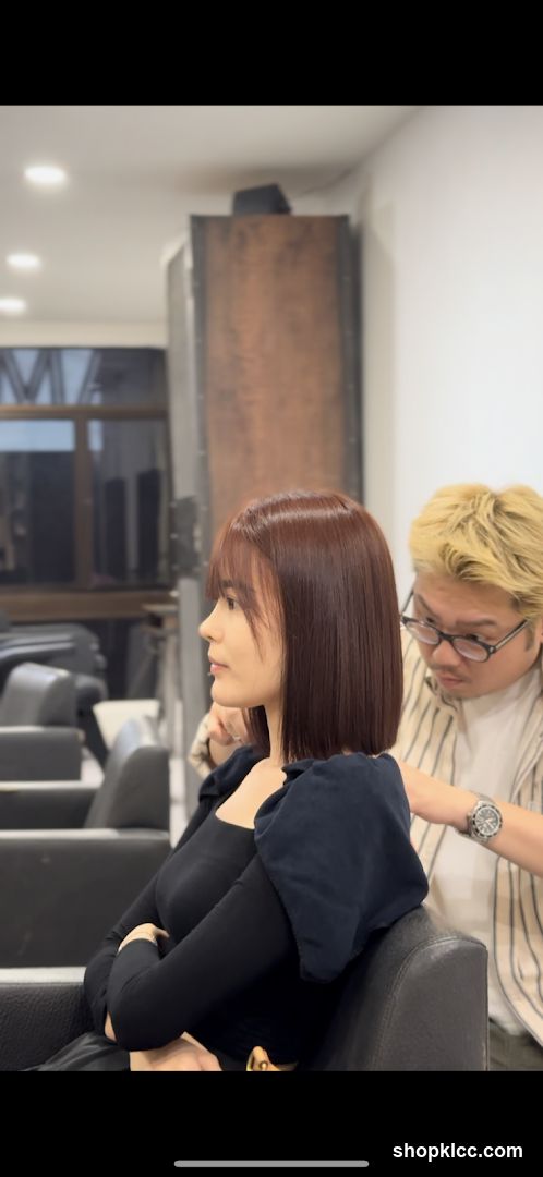 Hairdresser styling a client's hair