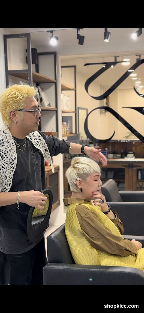 Hairdresser consulting with client
