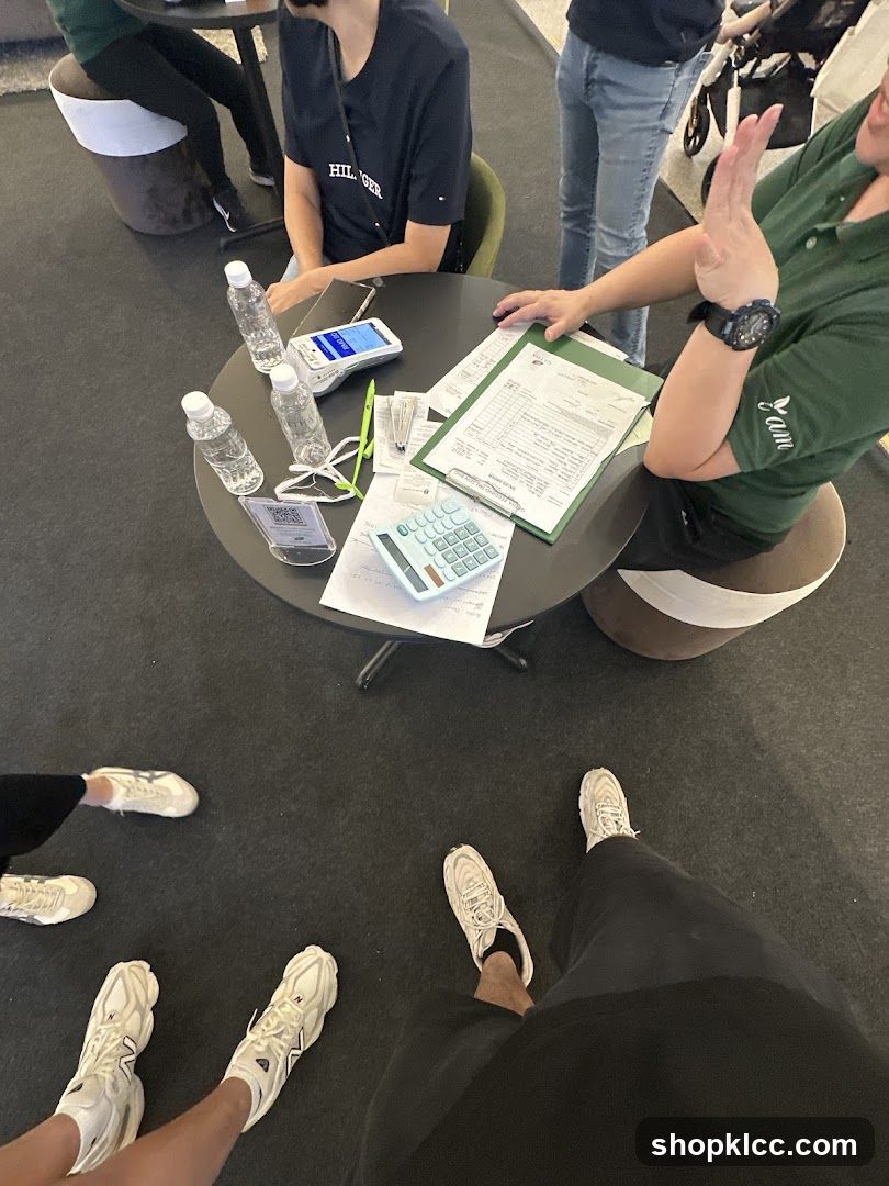 People gathered around a table with documents and a calculator
