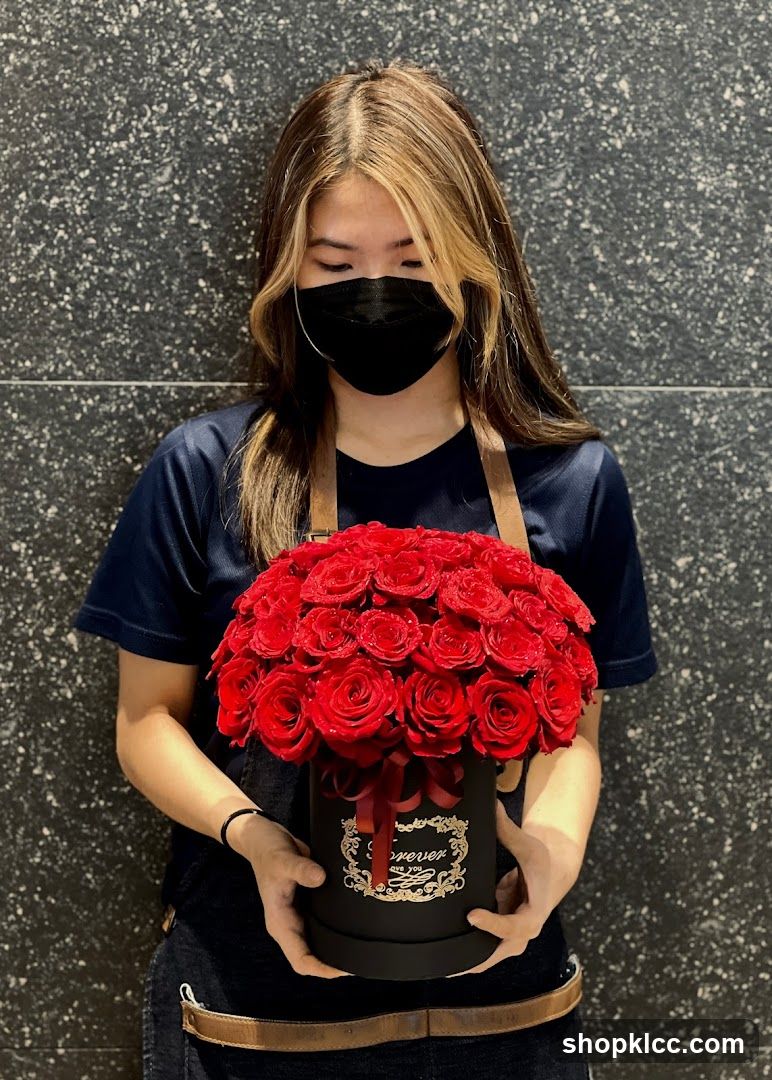Woman Holding a Box of Red Roses