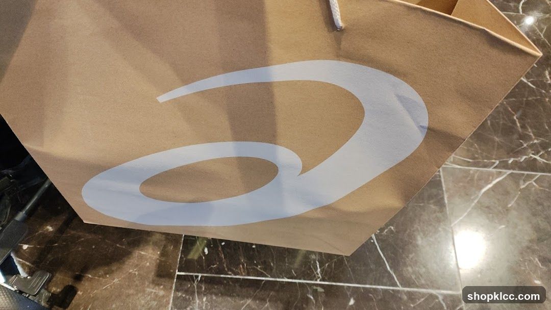 Brown paper shopping bag with white logo