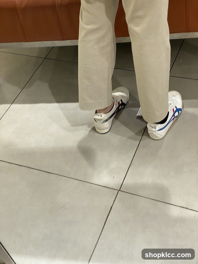 Person wearing white sneakers