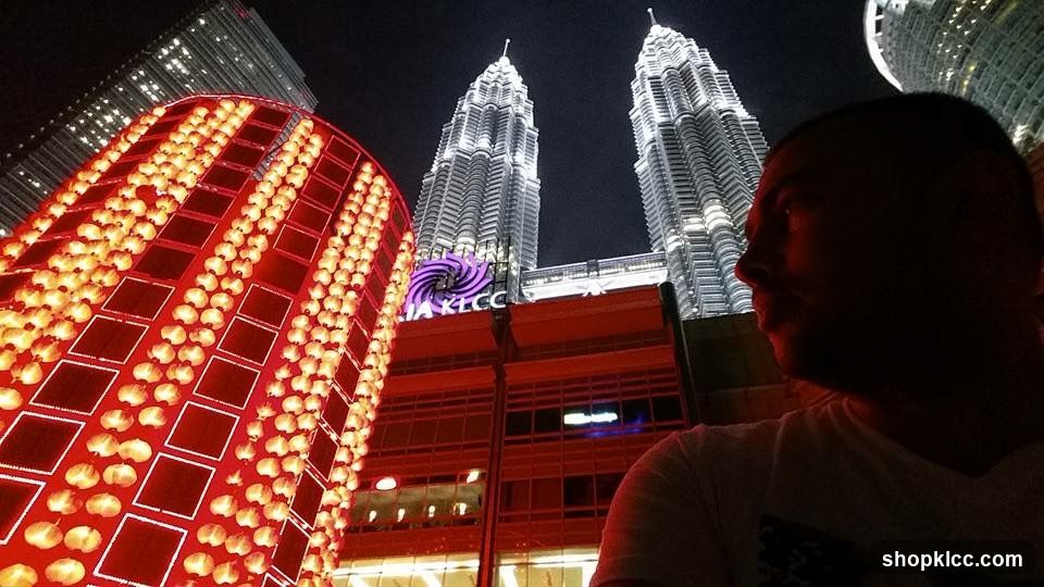 Night view of illuminated buildings and a man