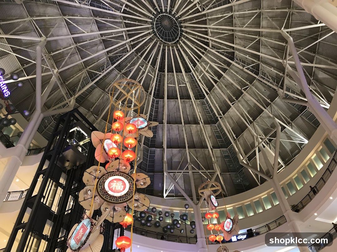 Interior of a large building with a domed ceiling and hanging decorations