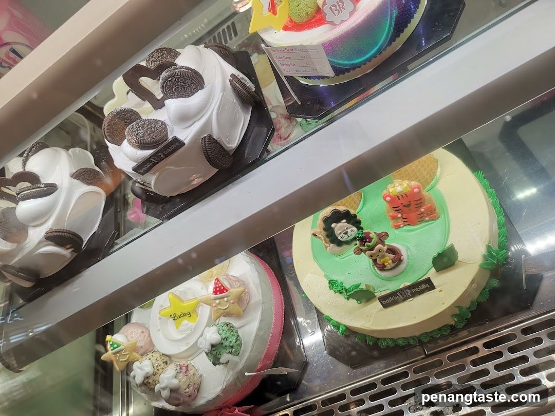 Assortment of Decorated Cakes in a Display Case