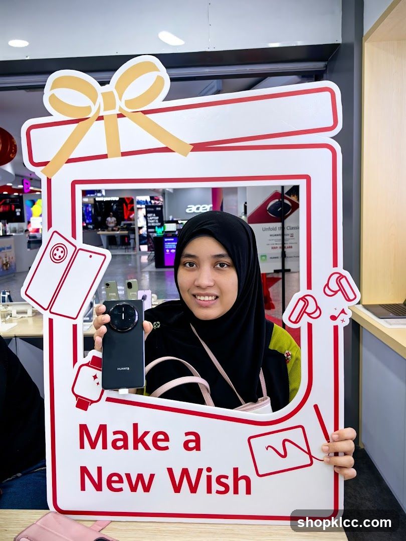 Woman holding a Huawei phone in a gift-themed photo frame