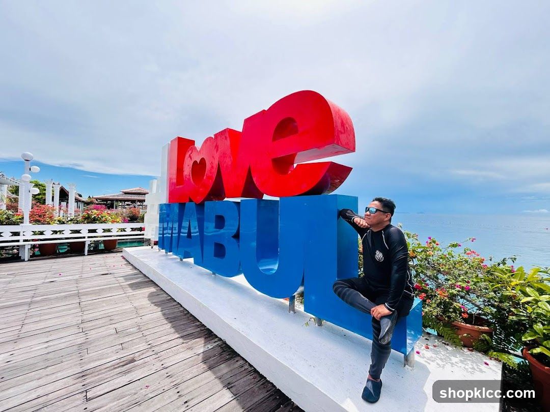Man posing by large "Love MABUL" sign