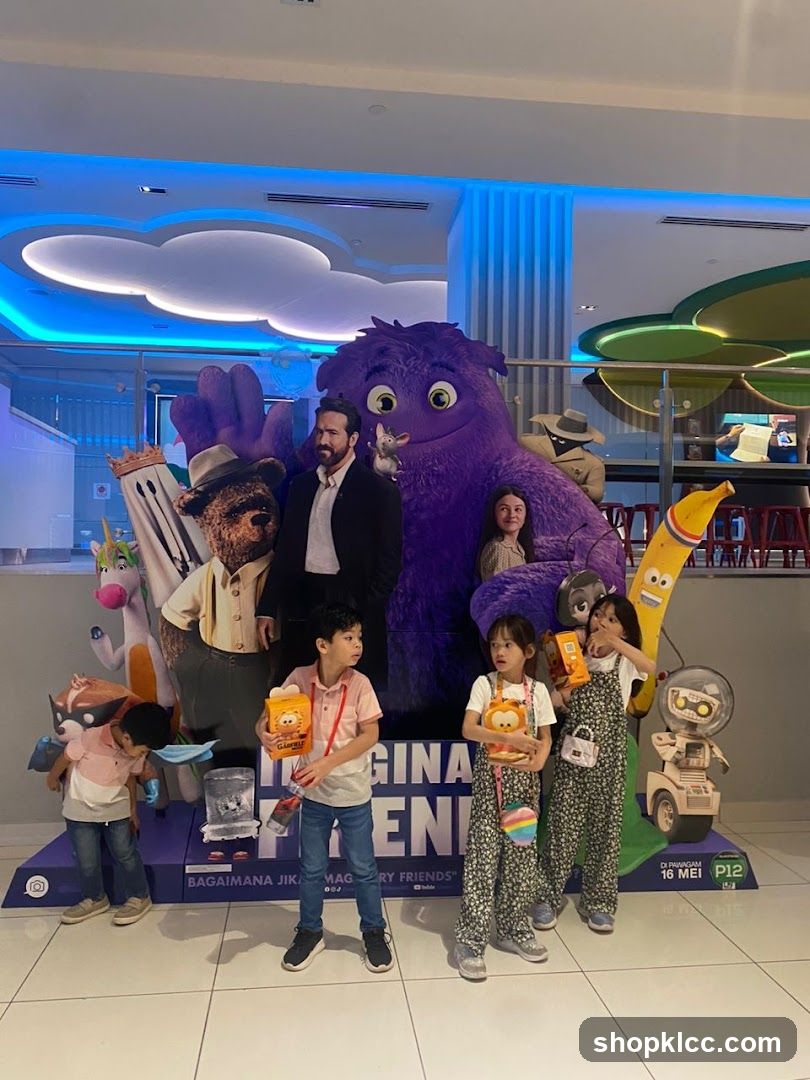 Children Posing with Movie Standee