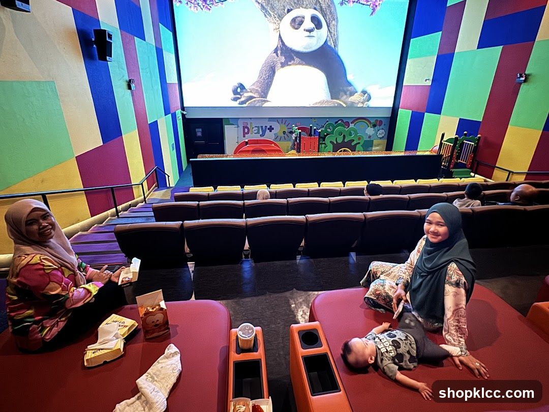 Family watching a movie in a colorful cinema