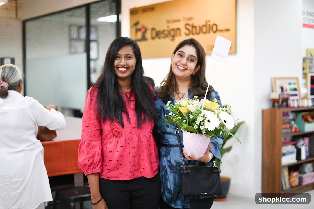 Two women with a flower arrangement