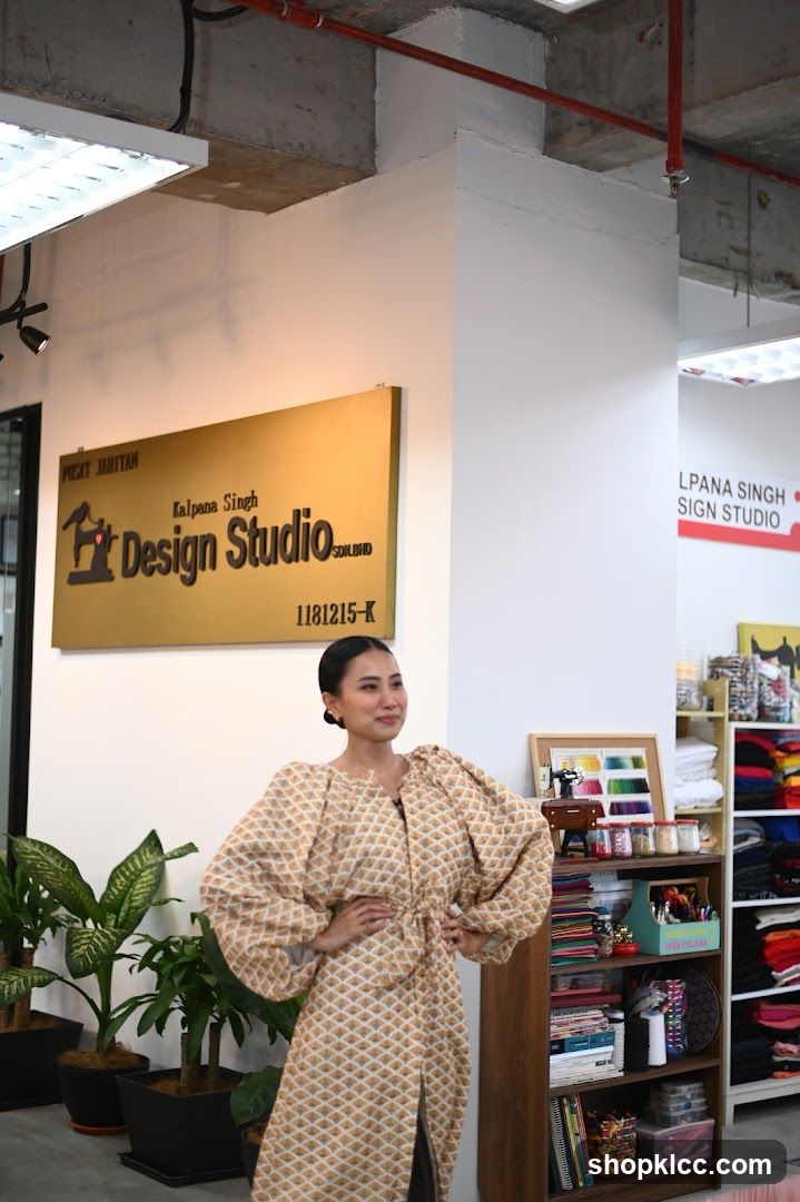 Woman in a patterned dress in a design studio