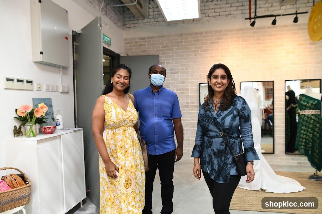Three people smiling in a boutique