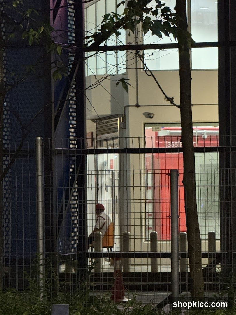 Person sitting in a chair near a red door
