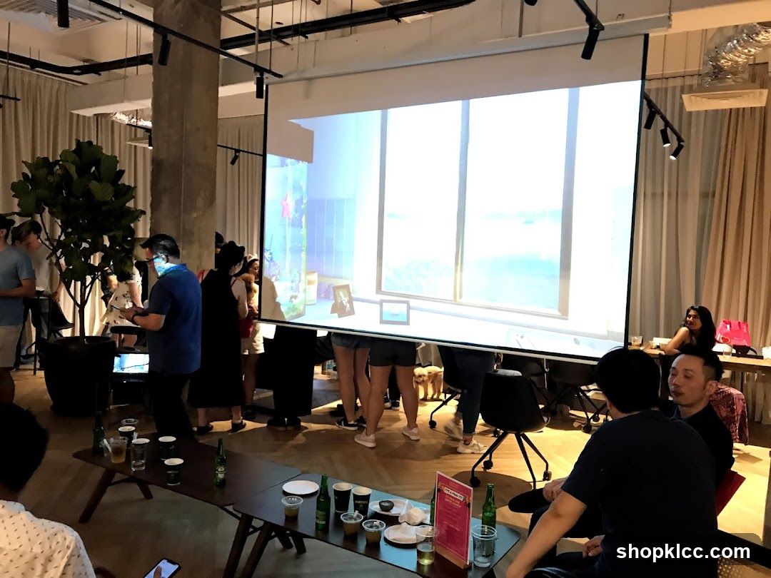 People gathered in a room with a projector screen