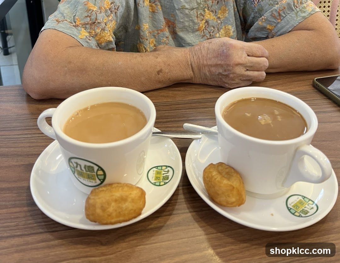 Two cups of milk tea with doughnuts on a table