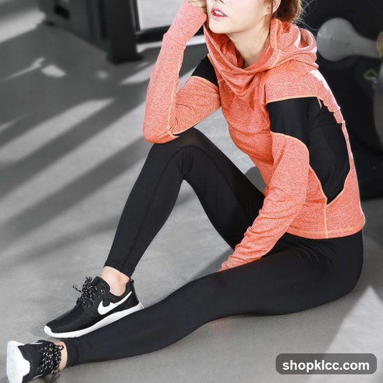 Woman in athletic wear stretching indoors