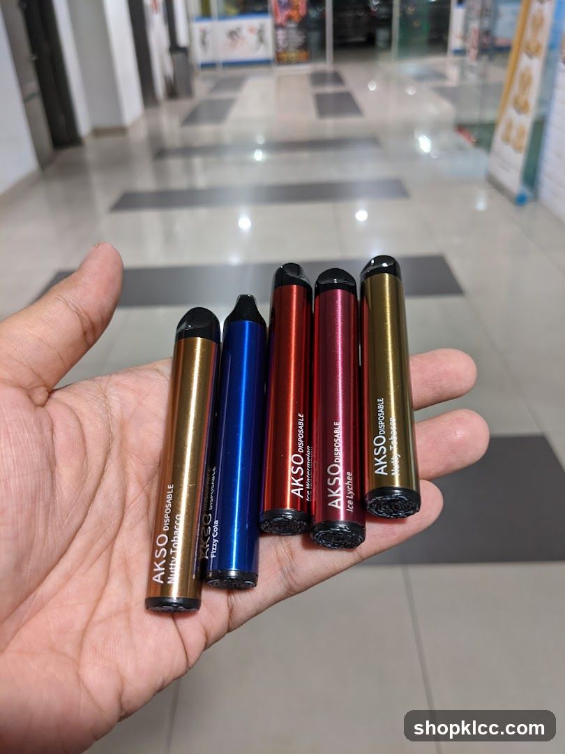Hand holding disposable vapes