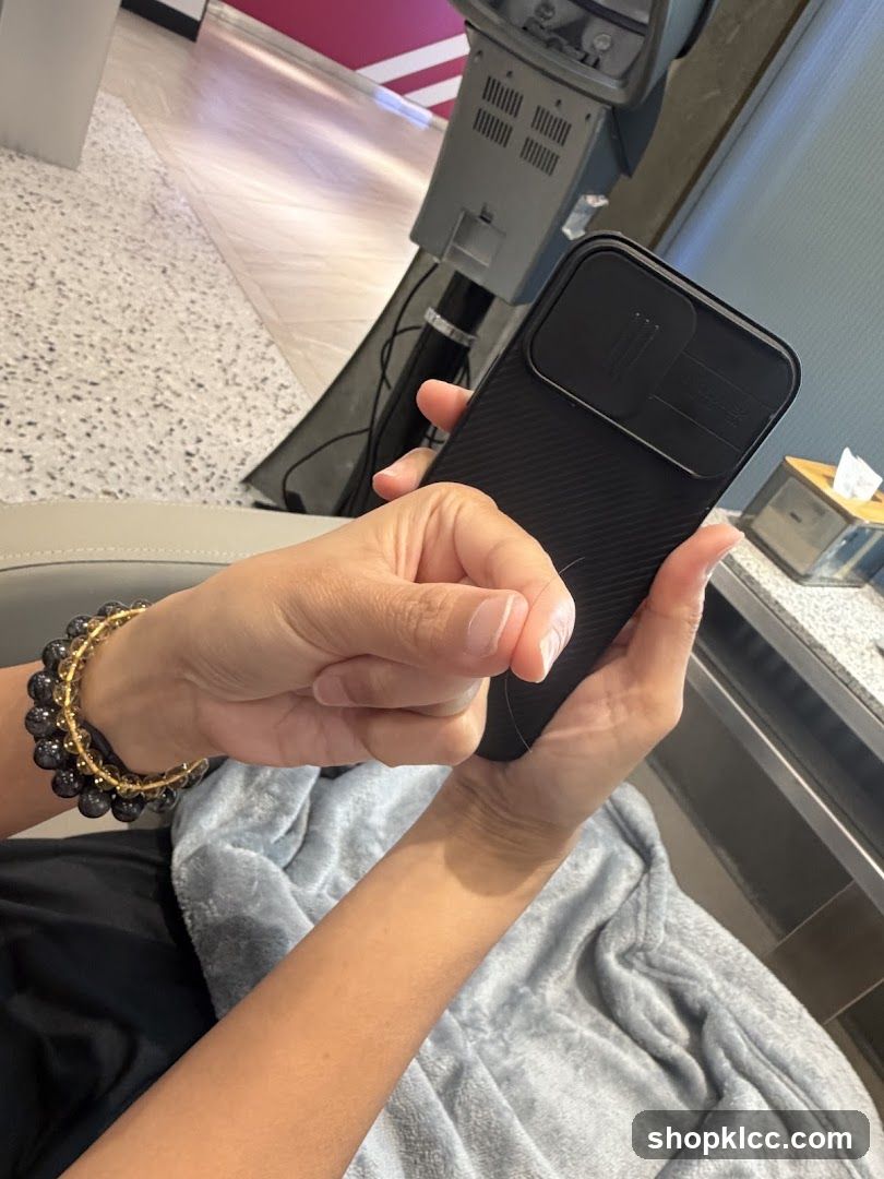 Person holding phone in salon or spa setting