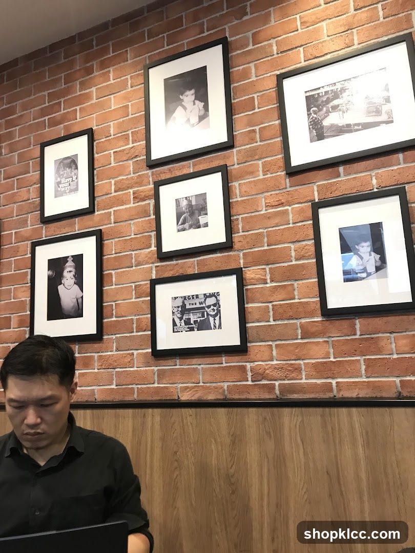 Interior with framed photos on brick wall
