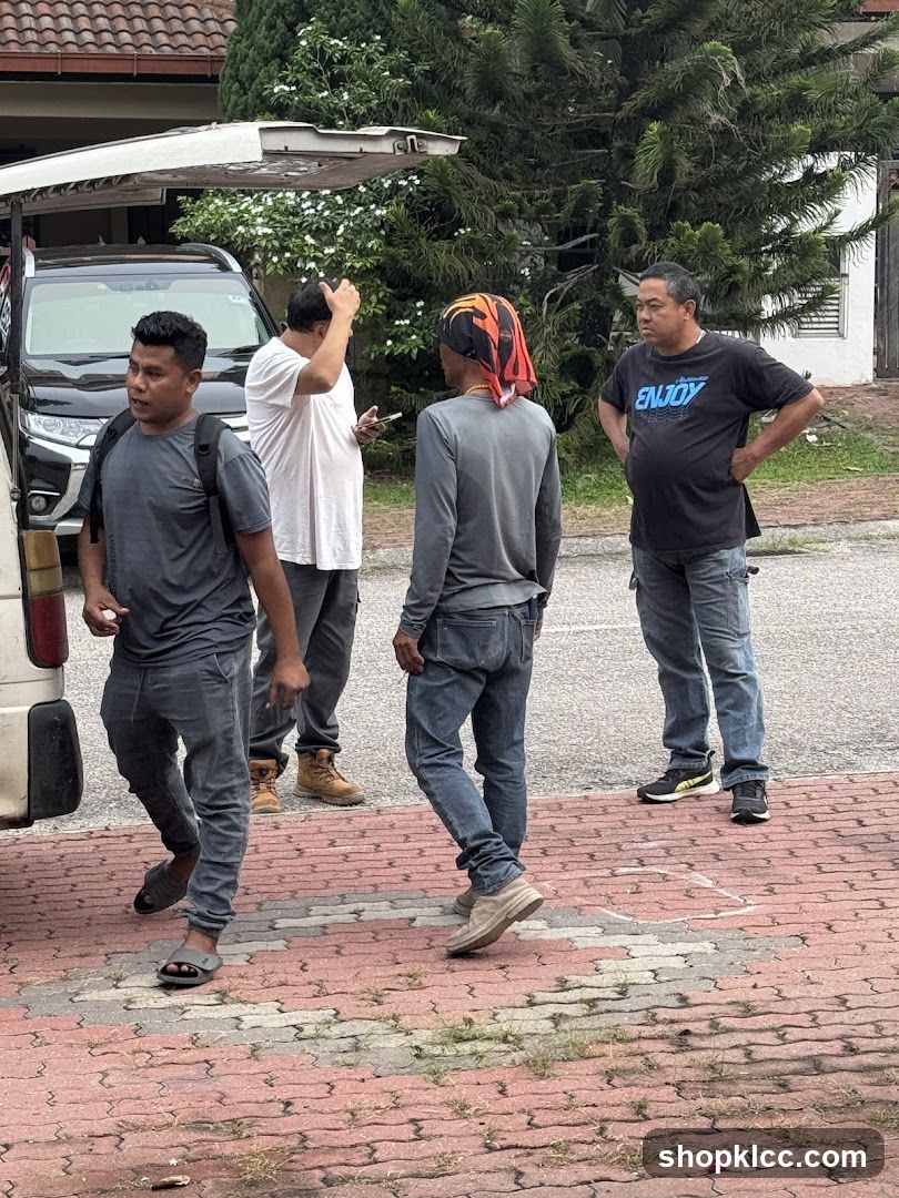 Group of men standing near a vehicle