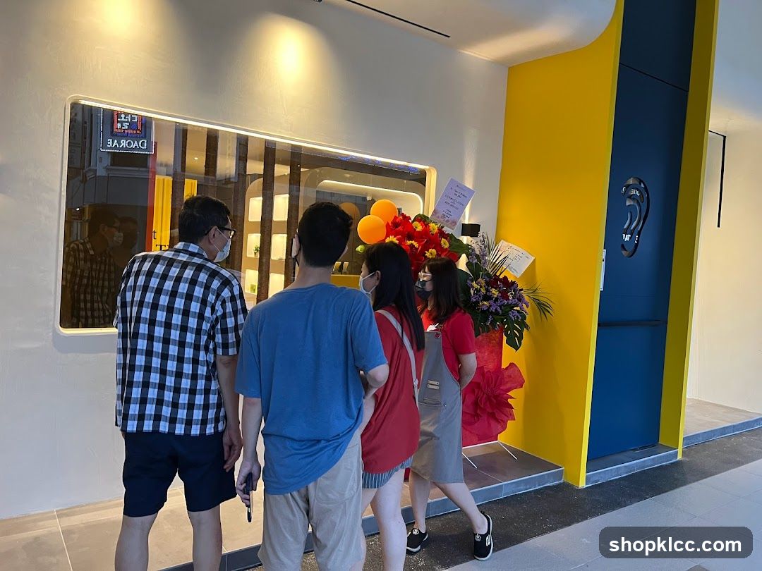 Group at Shop Entrance with Balloons and Flowers