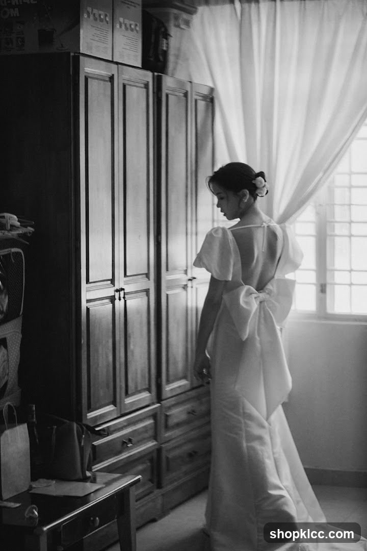 Bride in White Dress by Window