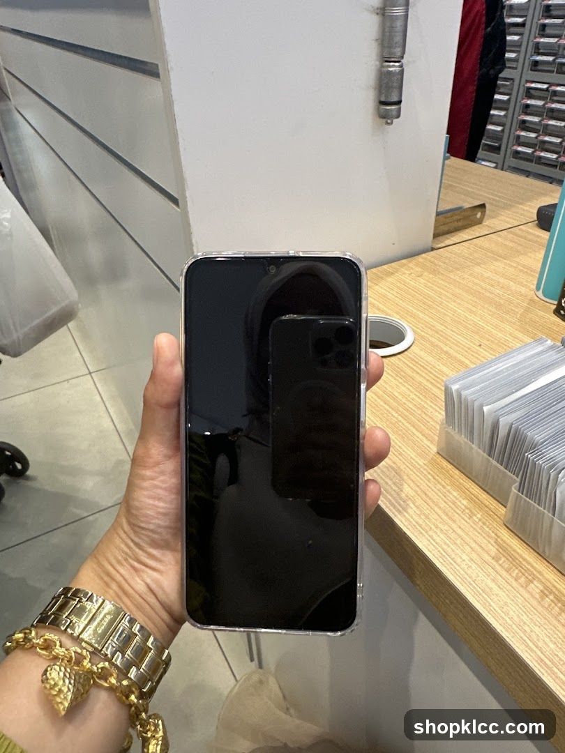 Hand holding smartphone in store interior