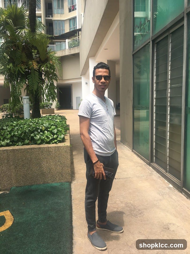 Man Standing Outside Building Entrance