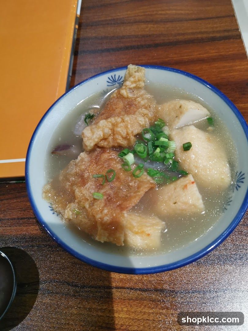 Bowl of Soup with Fried Dough and Tofu