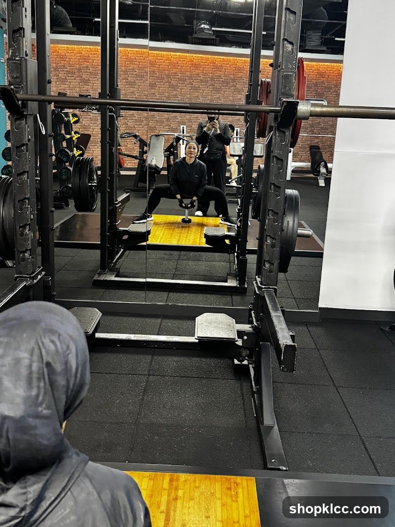 Gym Interior with Squat Rack and Mirror Reflection