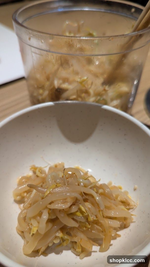 Bowl of pickled vegetables with a glass jar in the background
