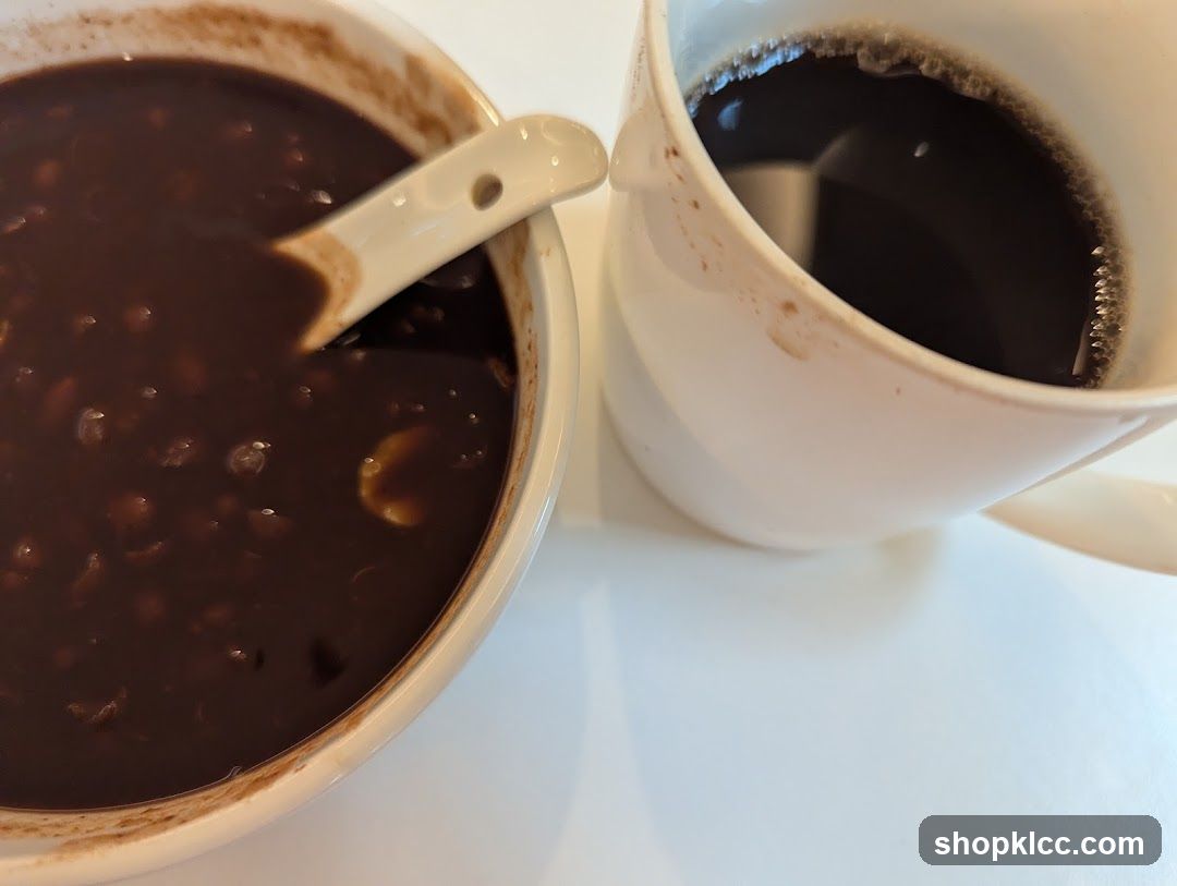 Bowl of dark soup and cup of coffee