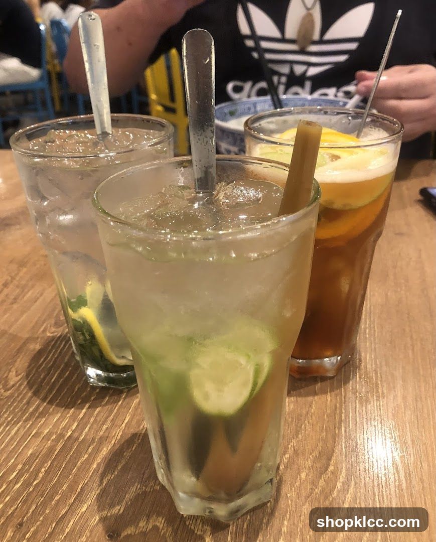 Three refreshing drinks on a wooden table