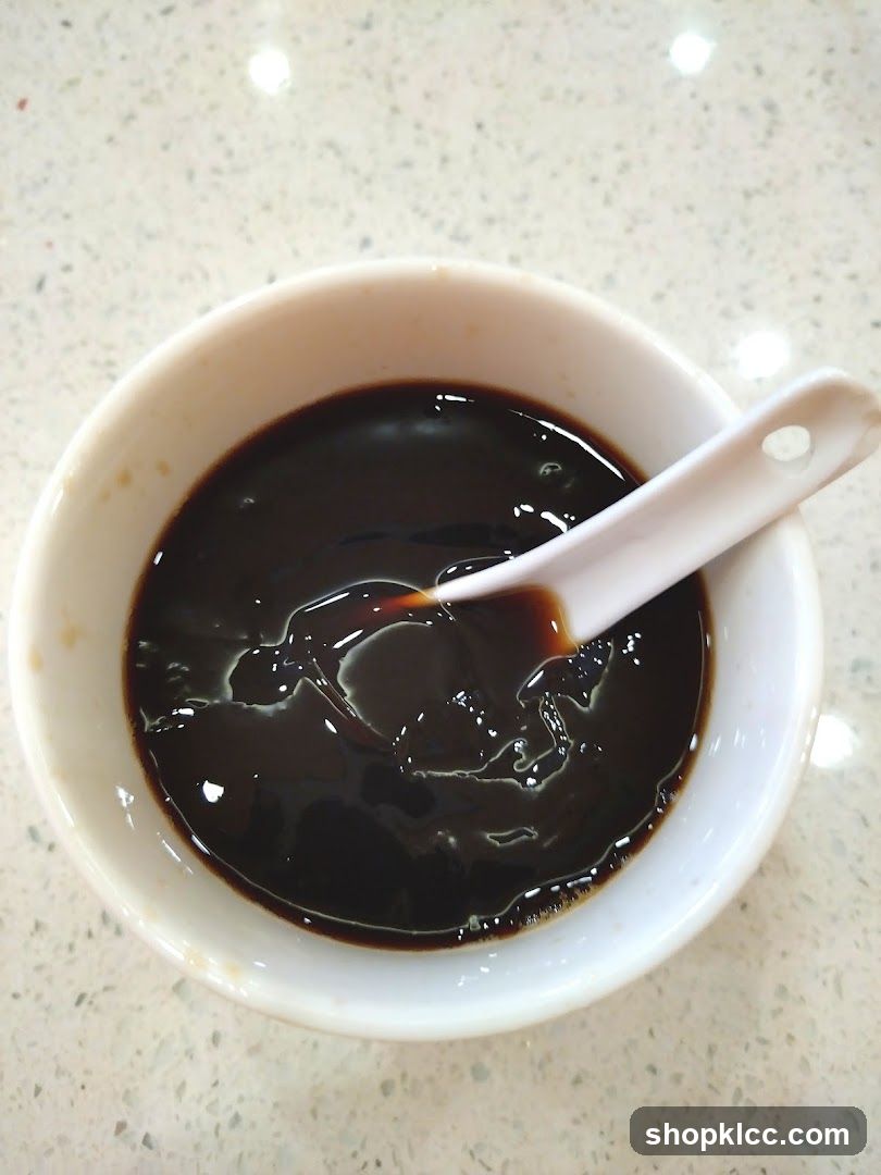 Bowl of Dark Liquid with Spoon