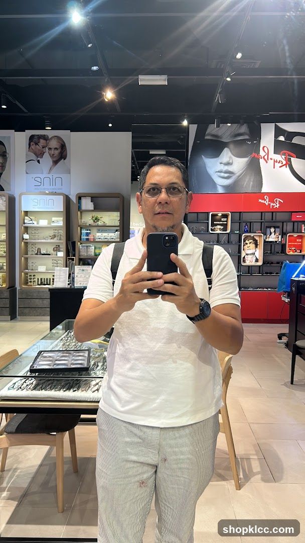 Man taking a selfie in an optical shop