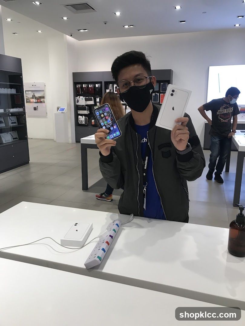 Man holding iPhones in store