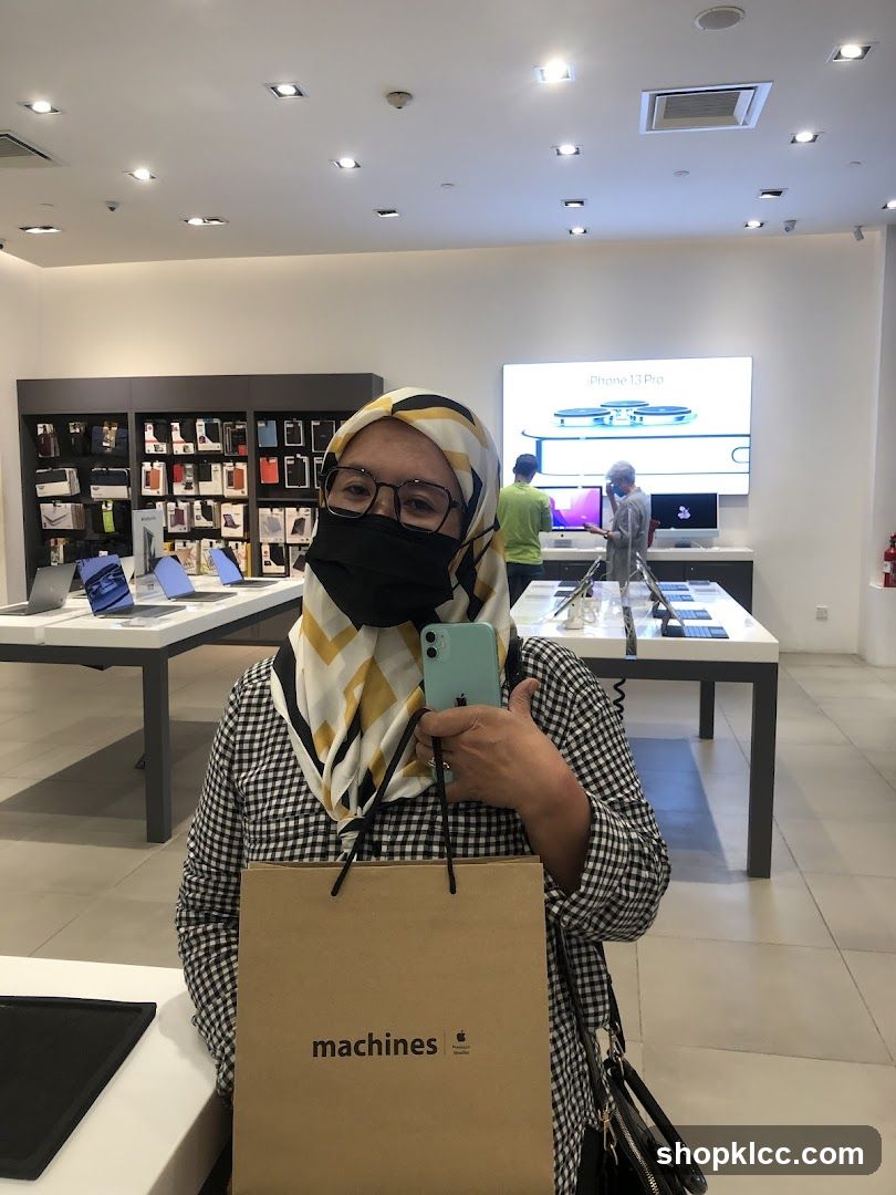 Woman holding a new iPhone in an Apple store
