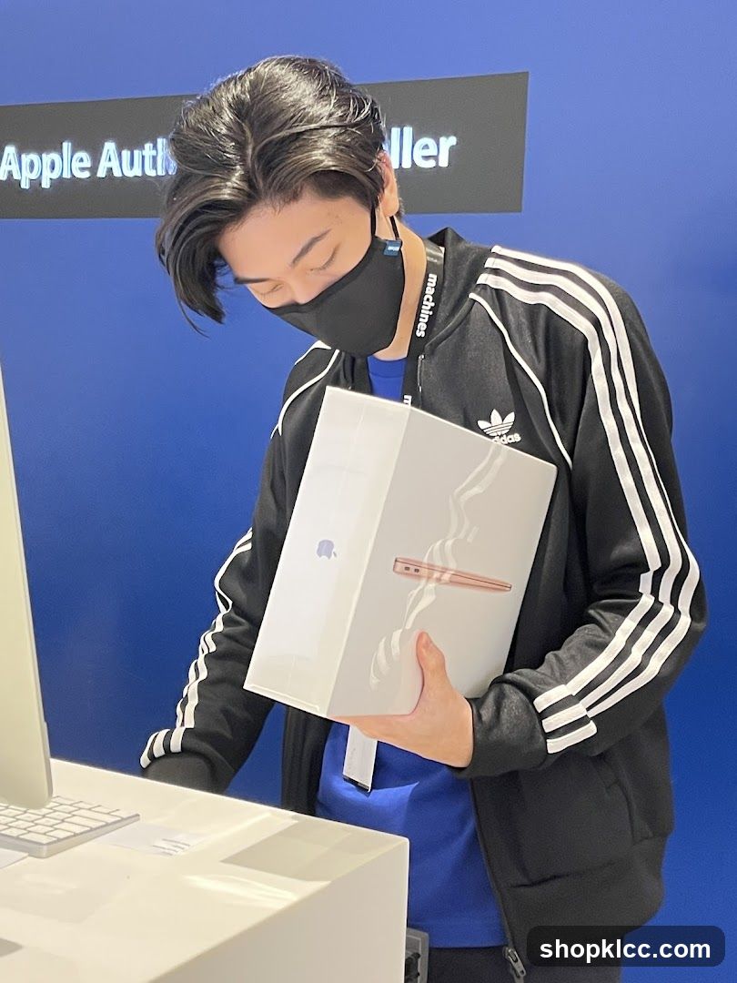 Man holding an Apple product box
